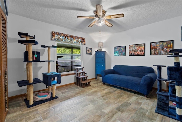 interior space with ceiling fan, hardwood / wood-style floors, and a textured ceiling