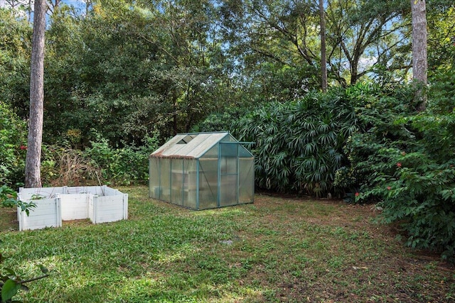 view of greenhouse with a lawn