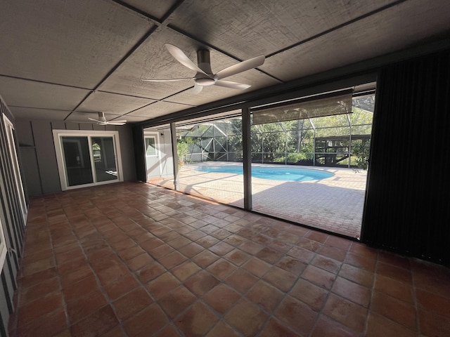 interior space featuring a swimming pool, plenty of natural light, and a ceiling fan