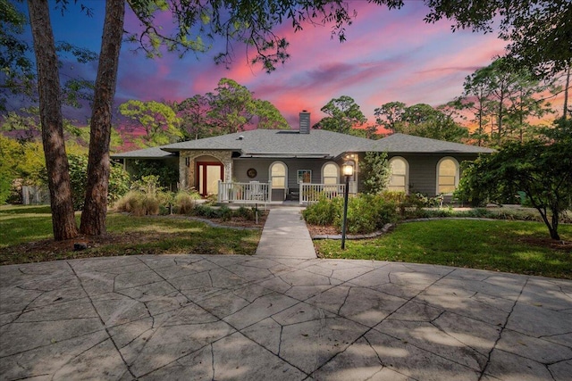 17602 Bridle Ct, Jupiter, FL 33478 - single story home with a chimney, a lawn, and a porch