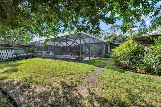 view of yard featuring a lanai and a swimming pool