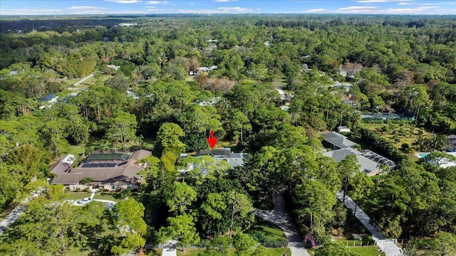 birds eye view of property with a wooded view