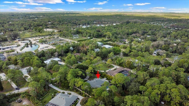 drone / aerial view featuring a wooded view