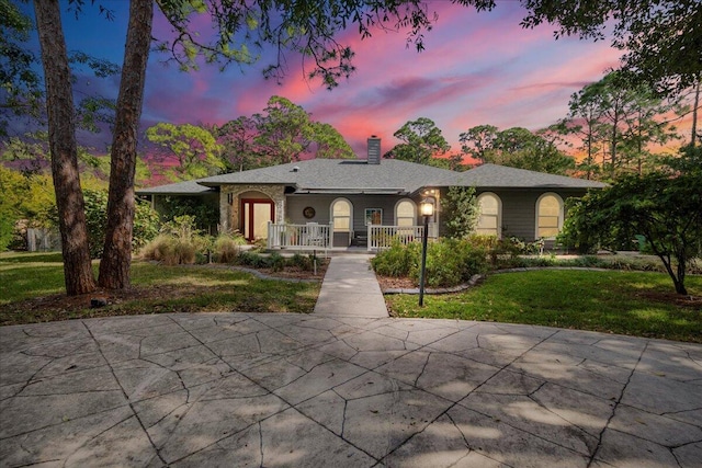 view of front facade featuring a lawn and a porch