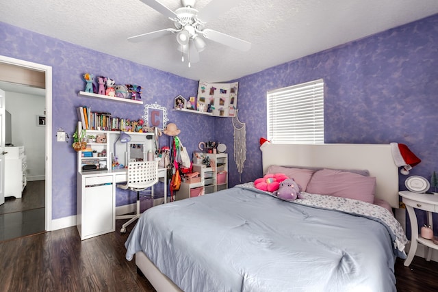 bedroom with dark wood-style floors, a textured ceiling, baseboards, and wallpapered walls