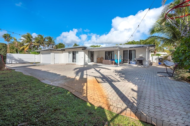 back of property featuring fence and stucco siding