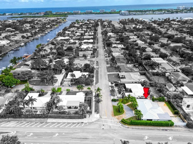 birds eye view of property with a water view and a residential view