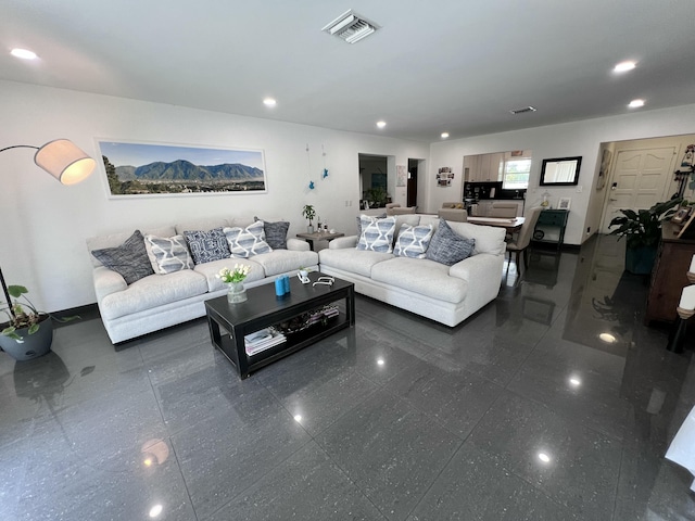 living area with recessed lighting and visible vents