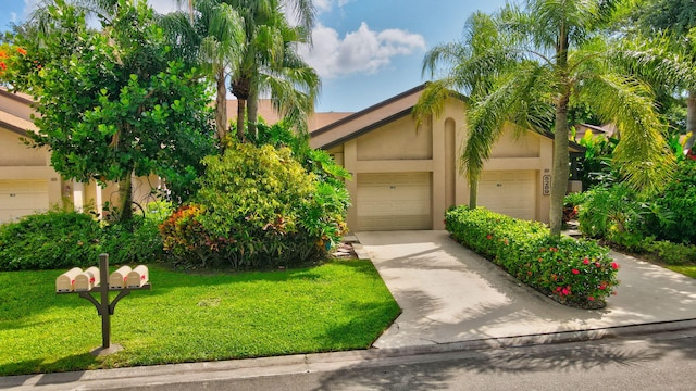 view of front of house featuring a garage and a front lawn