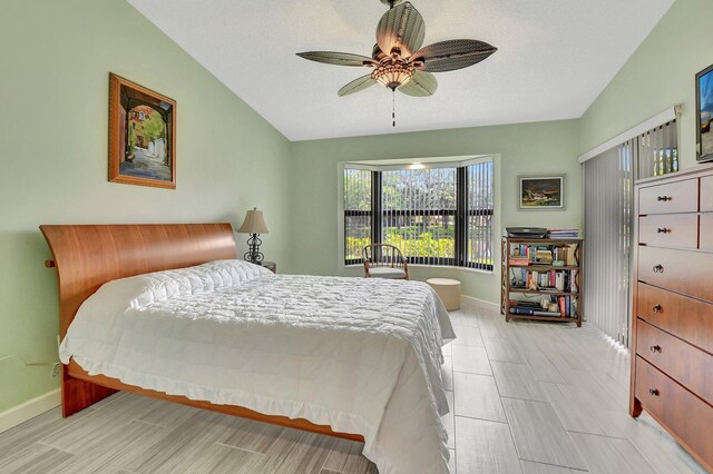 bedroom with ceiling fan, light hardwood / wood-style floors, ensuite bath, and a closet