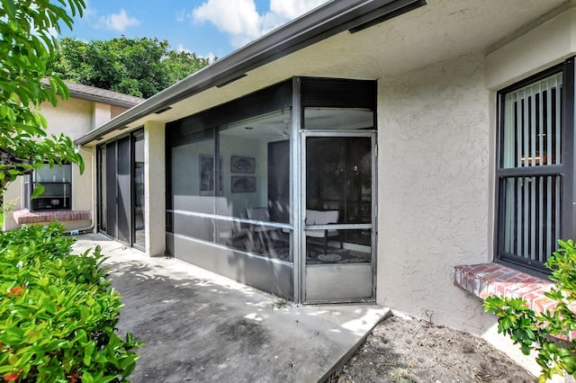 property entrance featuring a patio area