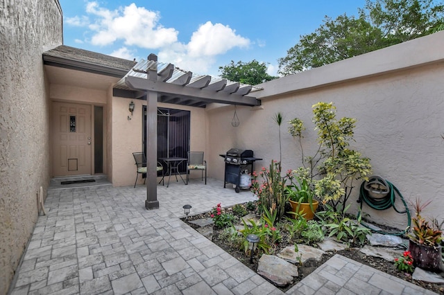 view of patio with a pergola and a grill