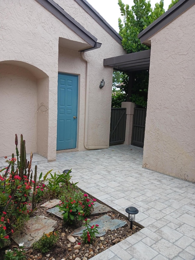 property entrance featuring a patio area