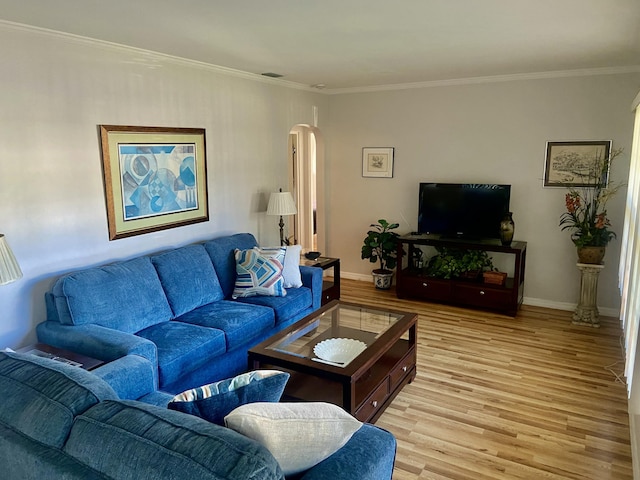 living room with light wood-type flooring and crown molding