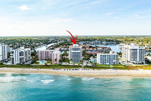 drone / aerial view featuring a water view and a view of the beach