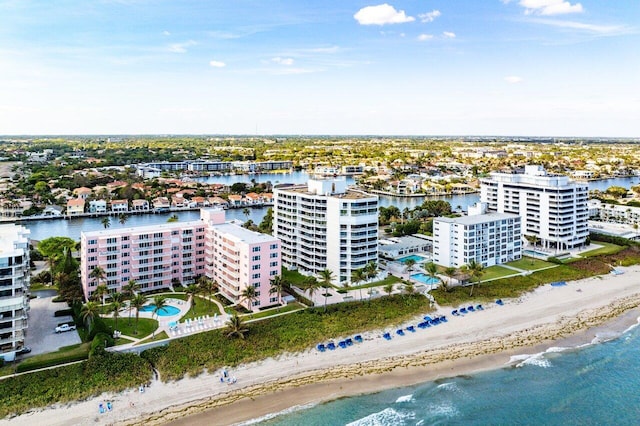 drone / aerial view with a water view and a beach view