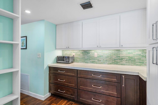 kitchen with tasteful backsplash, white cabinetry, dark brown cabinets, and dark hardwood / wood-style floors