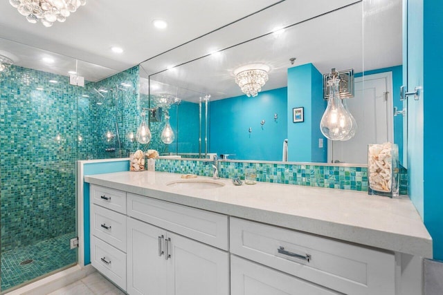 bathroom with backsplash, vanity, walk in shower, and tile walls