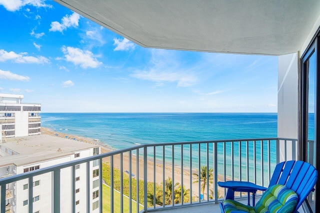 balcony featuring a beach view and a water view