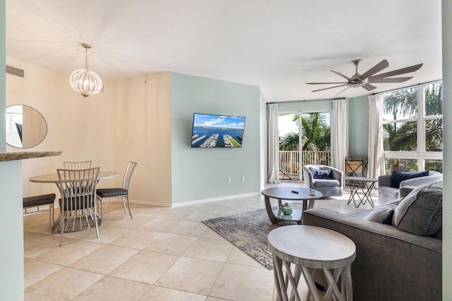 living room featuring light tile patterned flooring and ceiling fan with notable chandelier