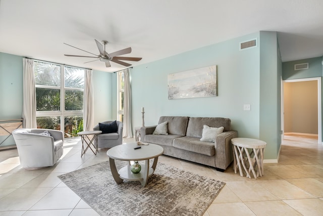 living room with ceiling fan and light tile patterned flooring