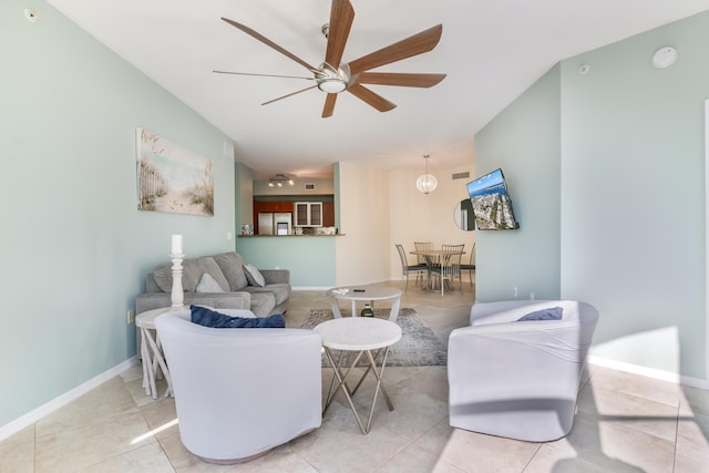 tiled living room with ceiling fan