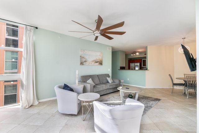 tiled living room featuring ceiling fan and heating unit