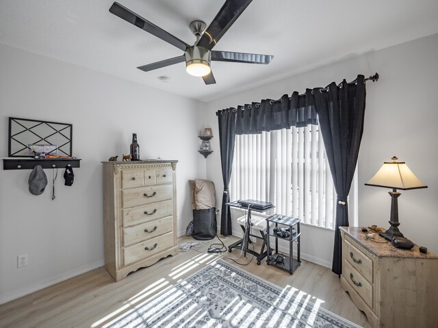 living area featuring ceiling fan and light hardwood / wood-style floors