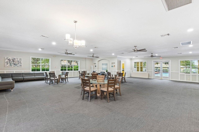 dining area with carpet flooring, a healthy amount of sunlight, and a textured ceiling