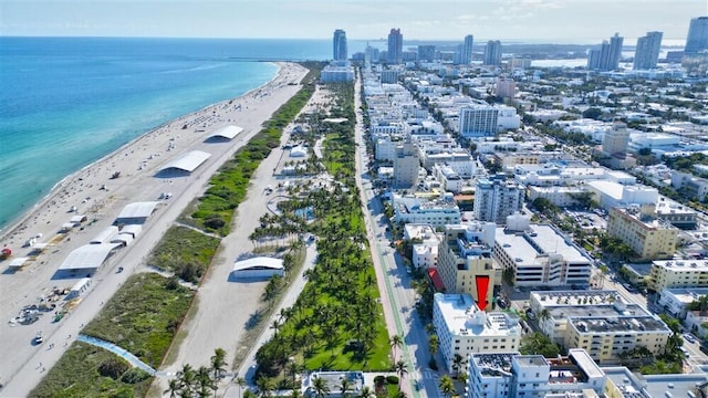 birds eye view of property featuring a beach view and a water view