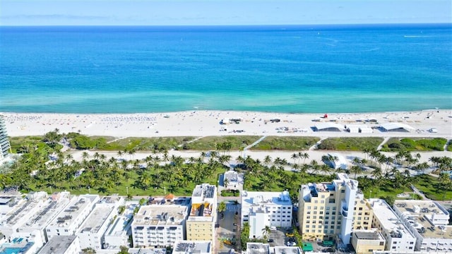 birds eye view of property with a view of the beach and a water view