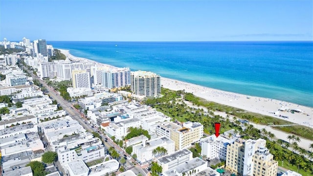 drone / aerial view featuring a view of the beach and a water view