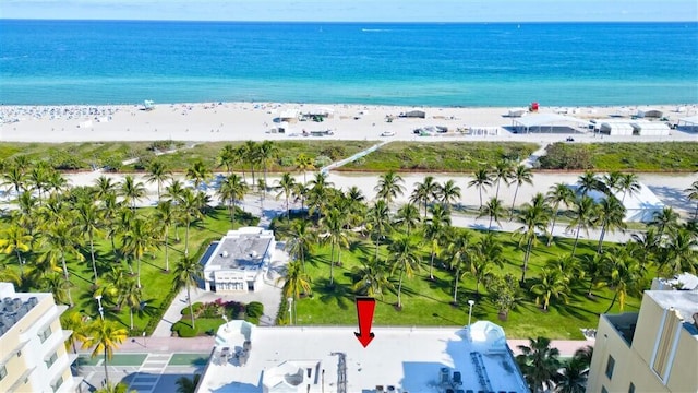 birds eye view of property featuring a water view and a beach view