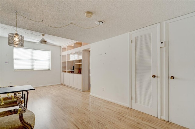 interior space featuring wood-type flooring and a textured ceiling