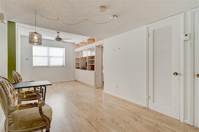 living area with hardwood / wood-style flooring and a textured ceiling