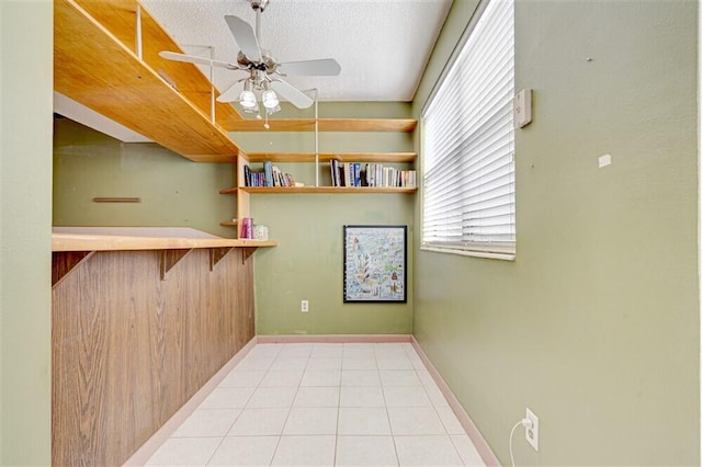 interior space featuring ceiling fan and a textured ceiling