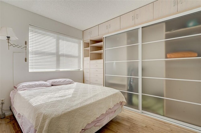 unfurnished bedroom with hardwood / wood-style flooring and a textured ceiling