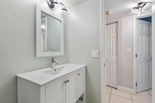 bathroom with tile patterned flooring and vanity