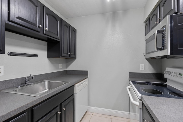 kitchen featuring sink, white appliances, and light tile patterned floors