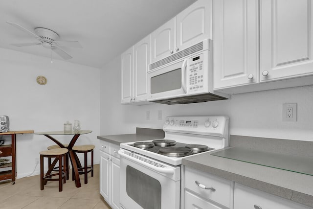 kitchen featuring white cabinets, ceiling fan, white appliances, and light tile patterned floors