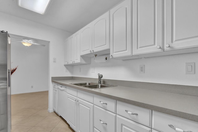 kitchen featuring white cabinets, sink, dishwasher, and light tile patterned flooring