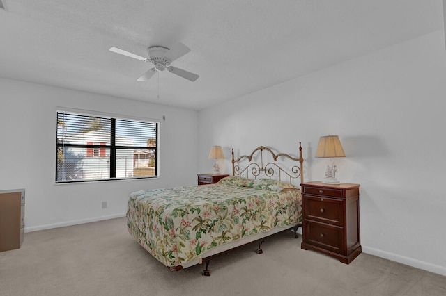 bedroom featuring ceiling fan and light carpet