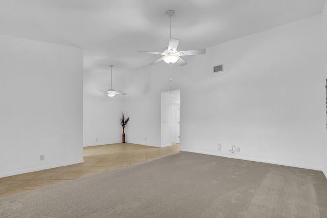 unfurnished room with ceiling fan and light tile patterned floors