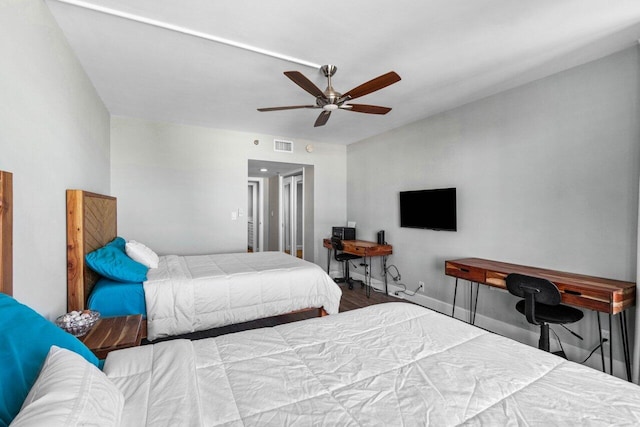 bedroom with ceiling fan and hardwood / wood-style flooring