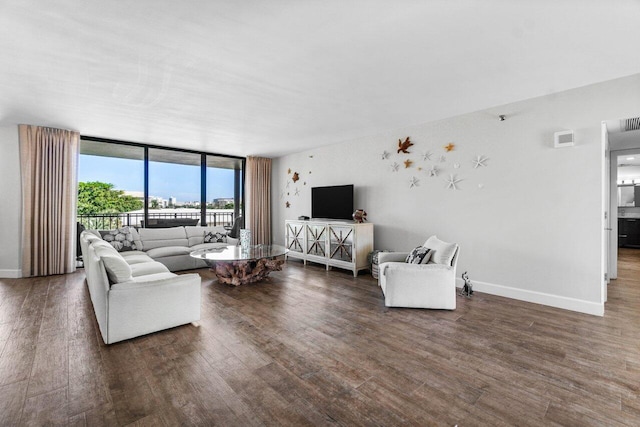 living room with a wall of windows and dark wood-type flooring