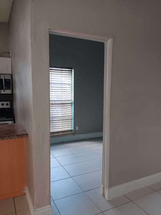 corridor with light tile patterned flooring