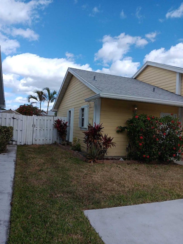 view of side of home with a yard