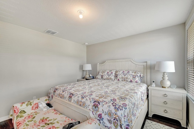 bedroom featuring dark hardwood / wood-style flooring