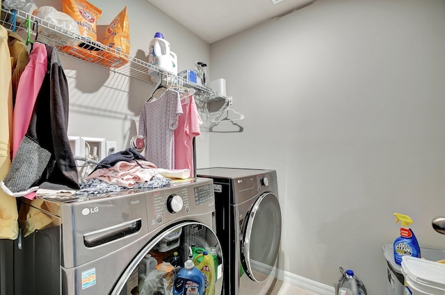 clothes washing area with washer and clothes dryer