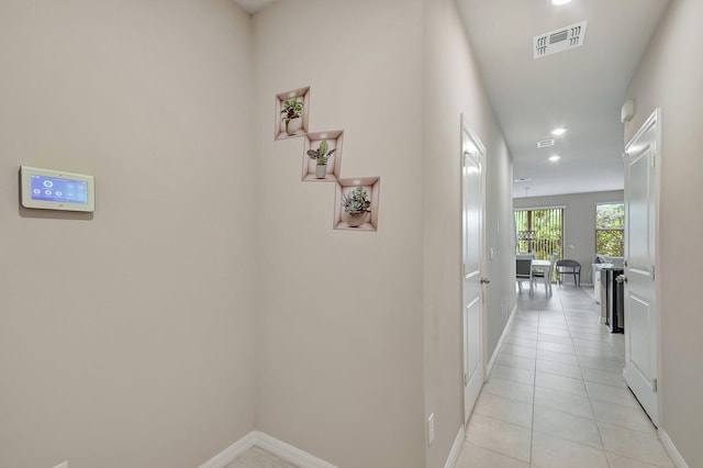 corridor featuring light tile patterned floors